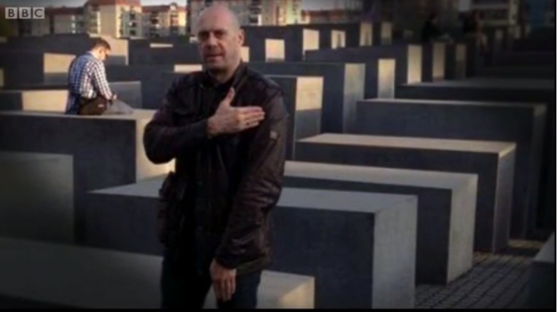Alain Soral performing the 'quenelle' in front of the Holocaust Memorial in Berlin.